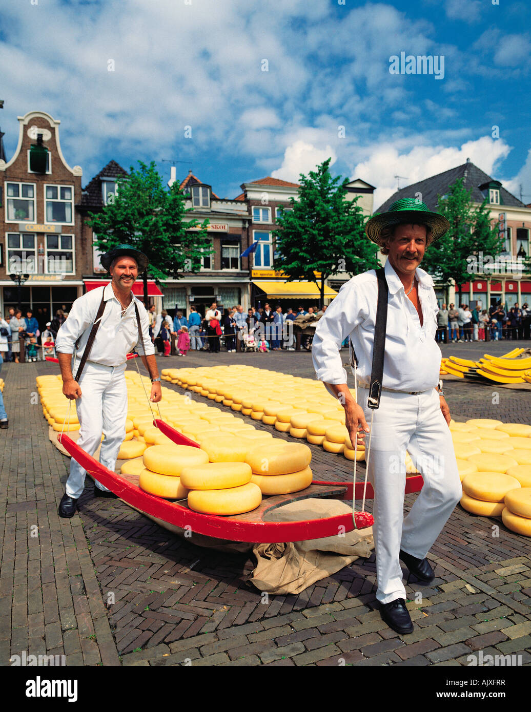 Netherlands, Amsterdam, Alkmaar, Cheese market, Men in traditional clothes carrying cheeses, Stock Photo