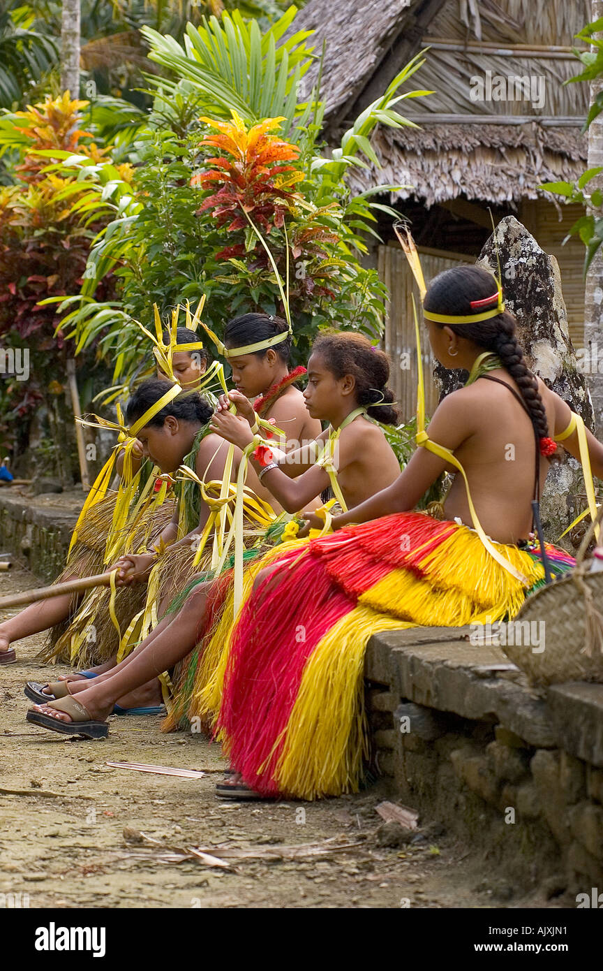 Yapese girls in traditional dress weaving grass Stock Photo