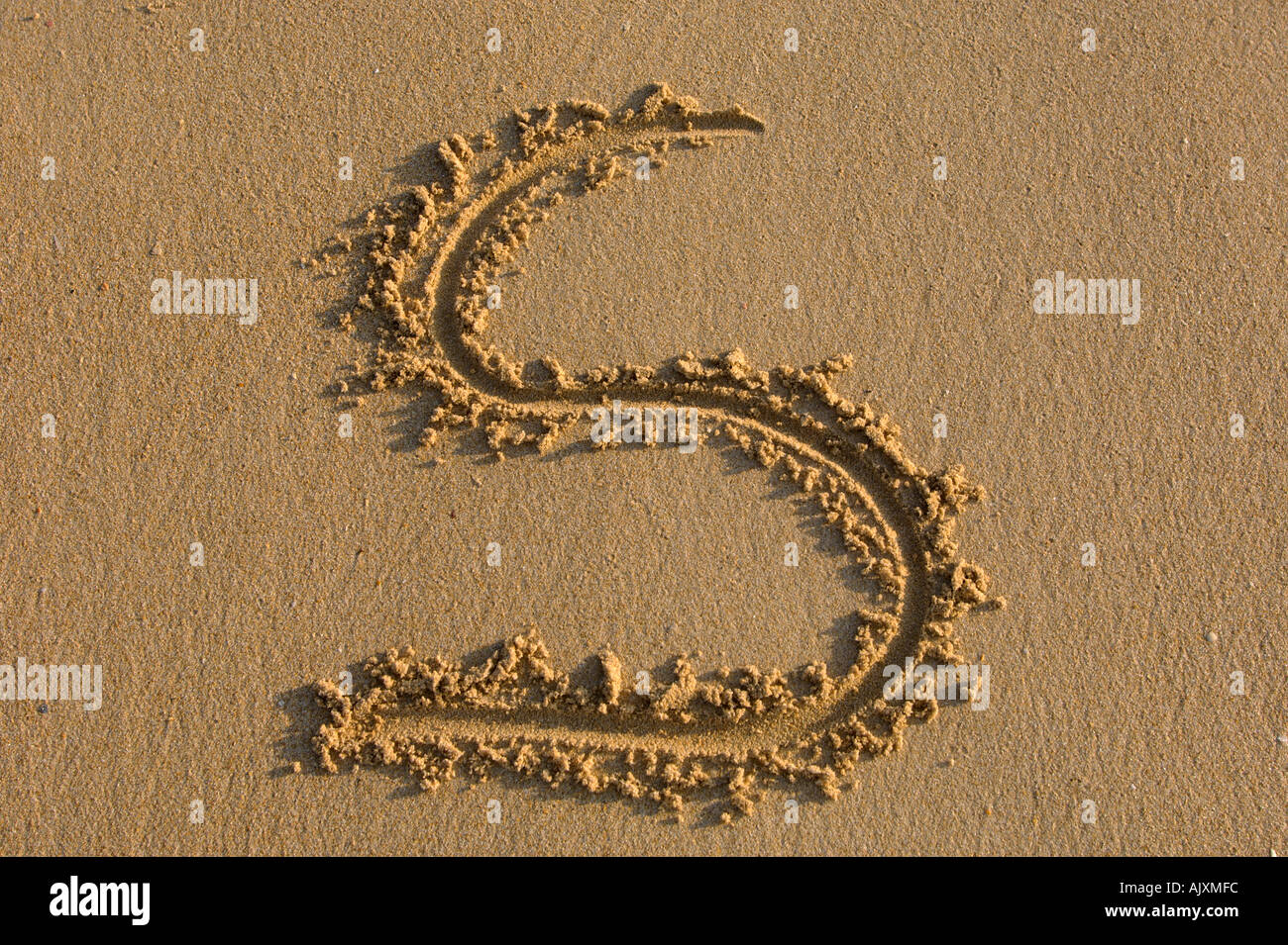 Alphabet hand writen letters on the sand Stock Photo - Alamy