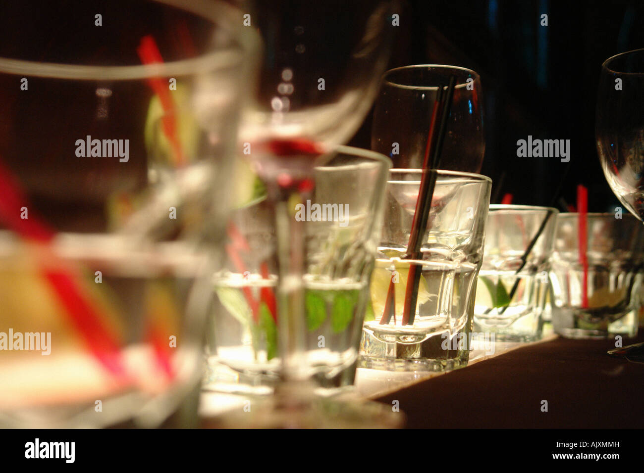 Still Life of Many Beverage Glasses on a Bottom Lit Shelf after a Party Stock Photo