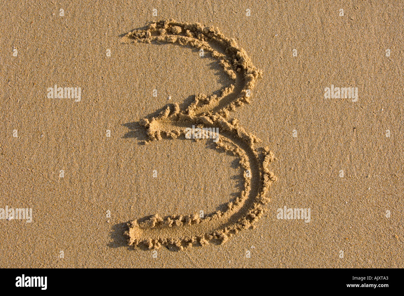 number hand writing numbers on the sand Stock Photo Alamy