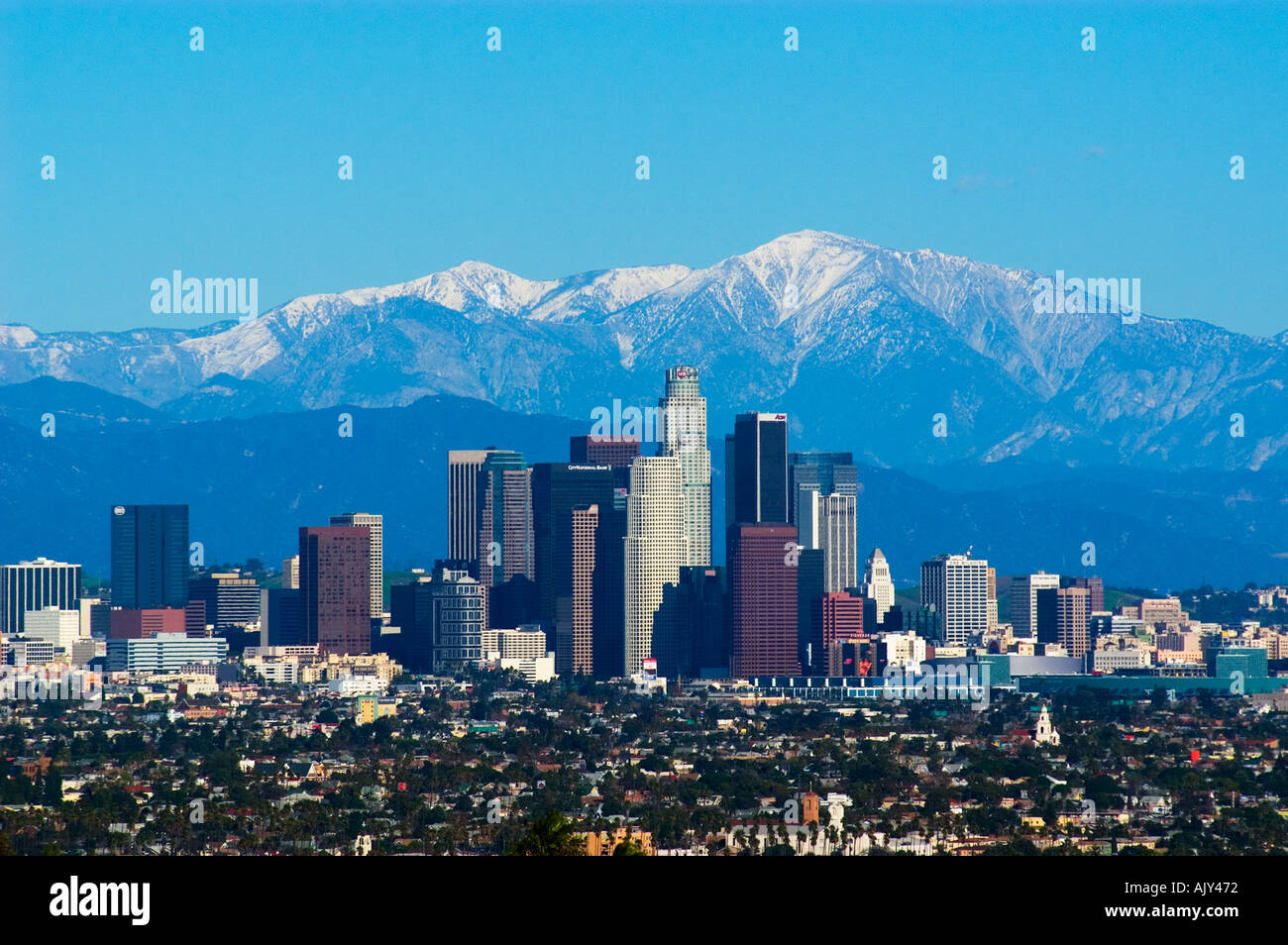 Snow covered San Gabriel Mountains behind downtown Los Angeles skyline