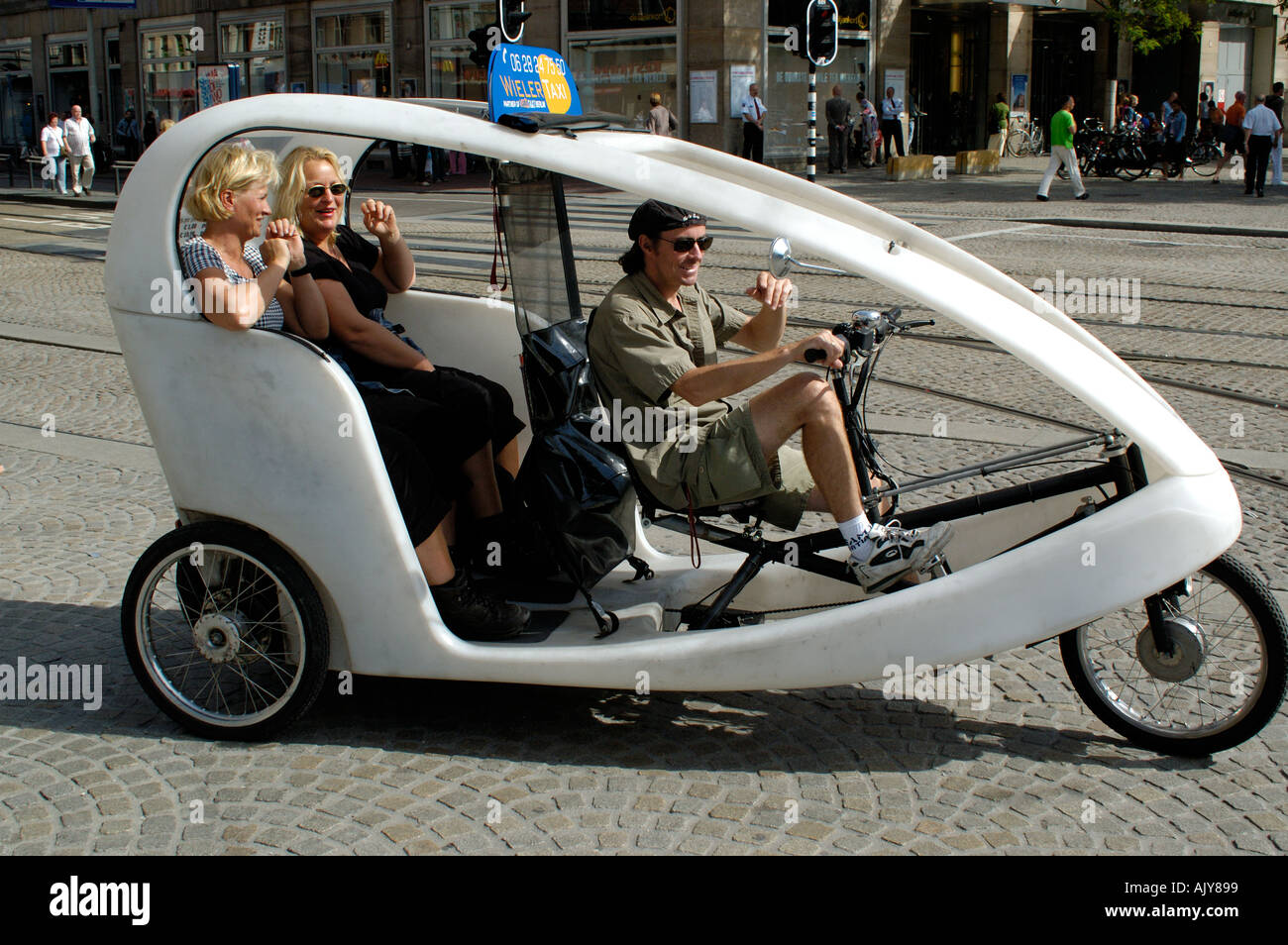 Netherlands Amsterdam Dam Square modern becak taxi Stock Photo Alamy