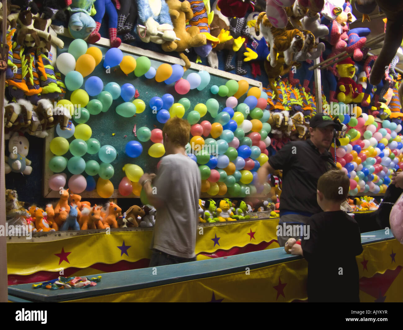 Boy carnival booth prepares throw hires stock photography and images