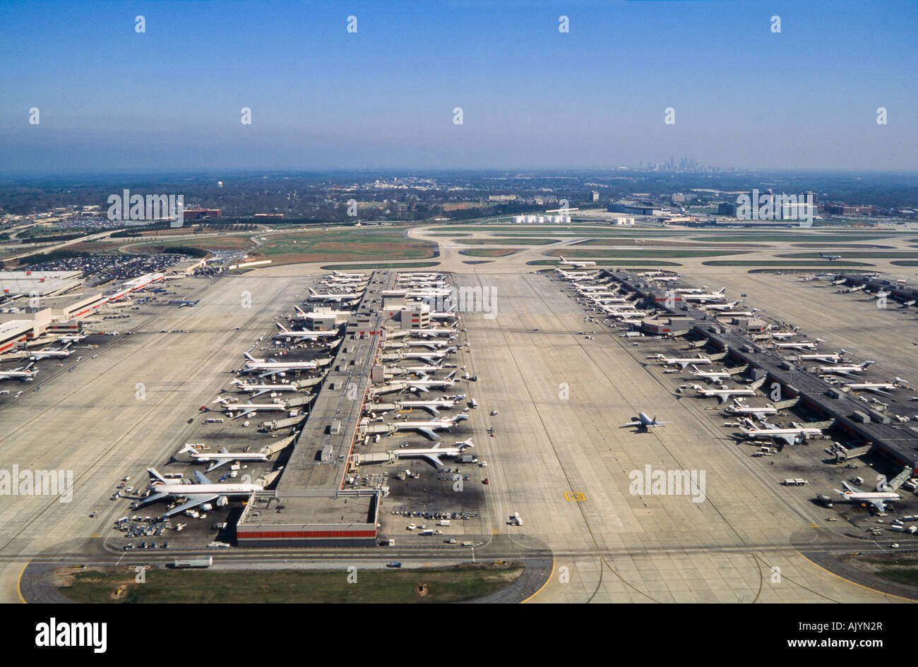 Commercial Airliner takeoff, over airport, Hartsfield International Airport, Atlanta Georgia, with aerial view of airport. Stock Photo