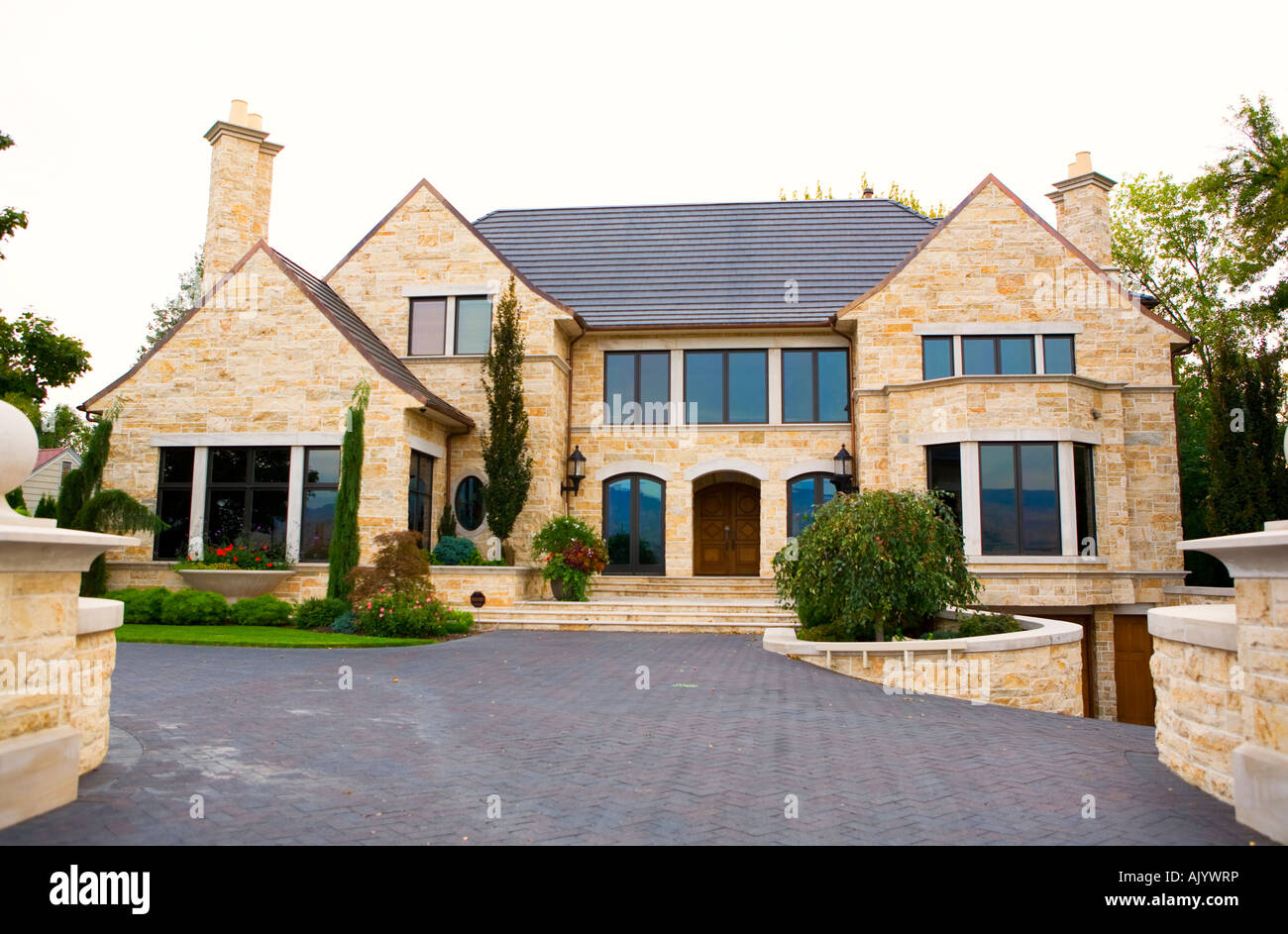 Large expensive modern home with stone exterior Stock Photo - Alamy