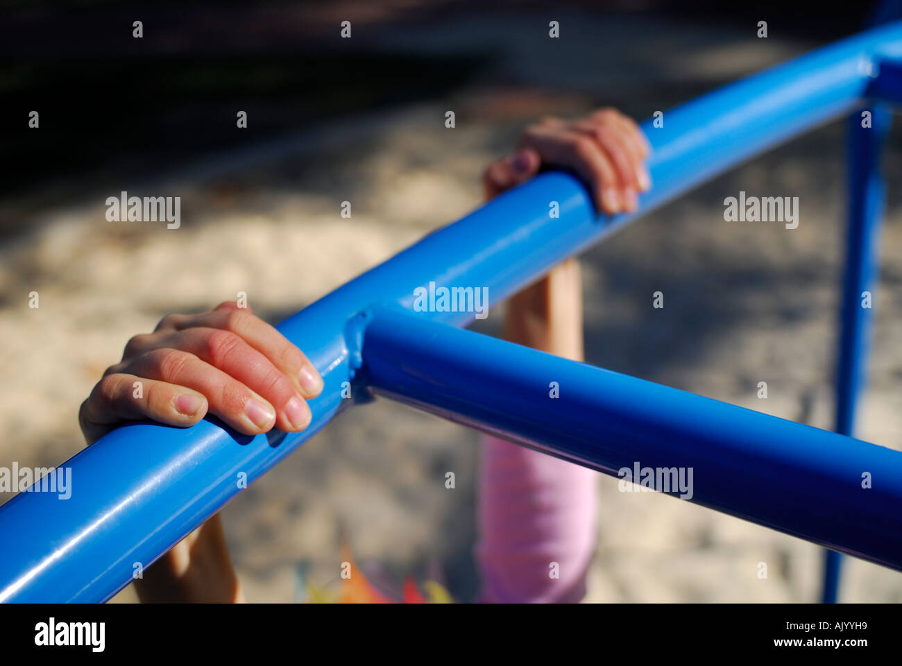 Close Up Of Child Hanging By Hands On To Playground Climbing Frame With close-up-of-child-hanging-by-hands-on-to-playground-climbing-frame-with