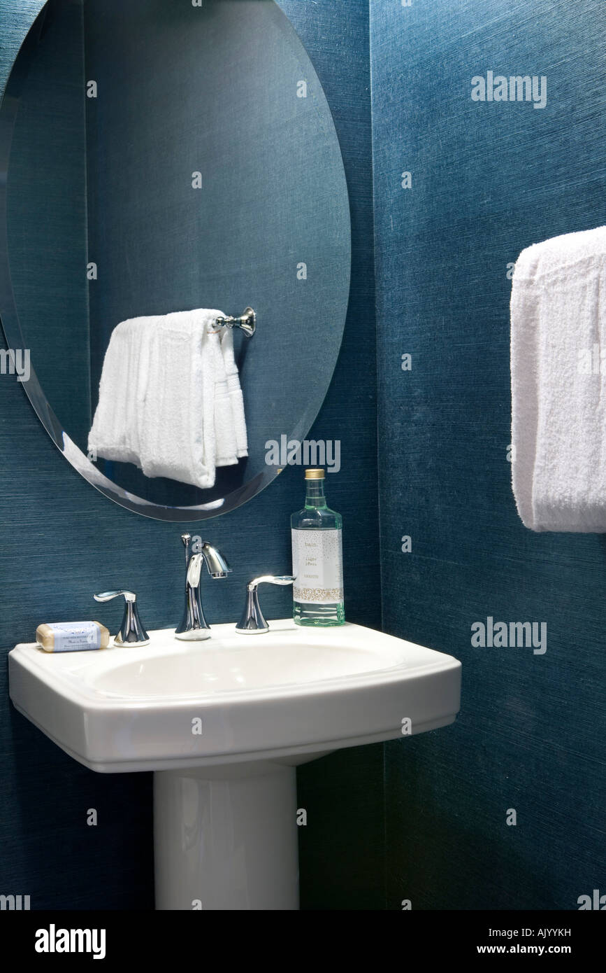 Interior of powder room vanity with sink, mirror and hanging towel Stock Photo