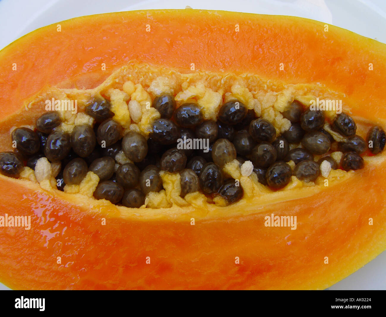 Paw Paw Fruit cut open to show the seeds and edible flesh Papaya Stock Photo