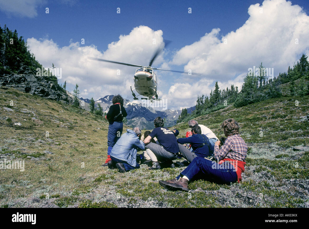 Helihikers prepare to board a helicopter in the high country of the Bugaboo Mountains in British Columbia Stock Photo