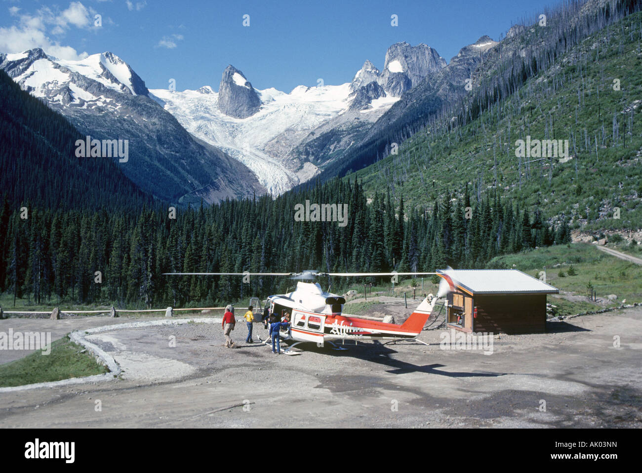 Helihikers deplane from a helicopter in the high country of the Bugaboo Mountains in British Columbia Stock Photo