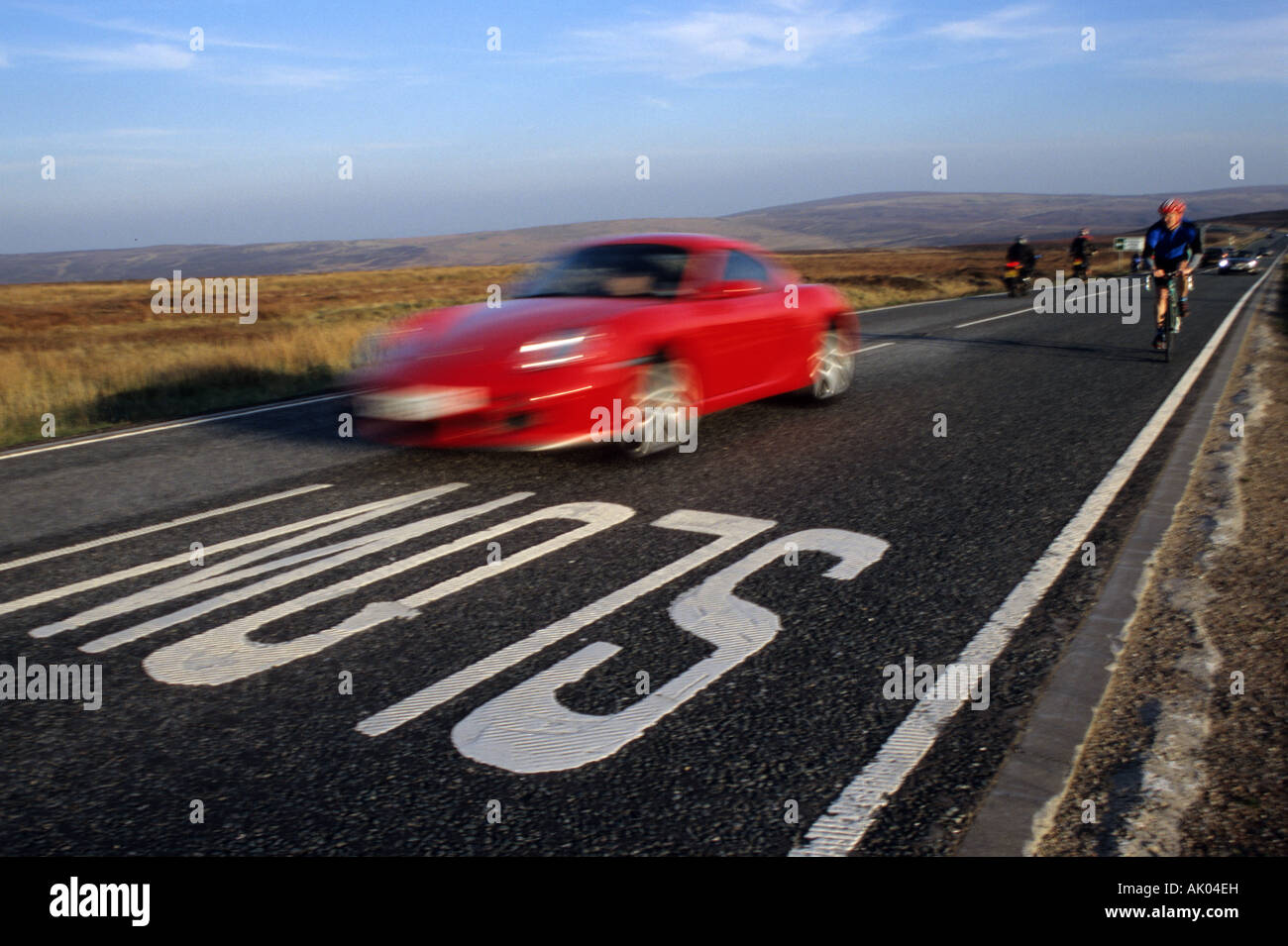 Red Porsche Car Passing Slow Road Marking Stock Photo