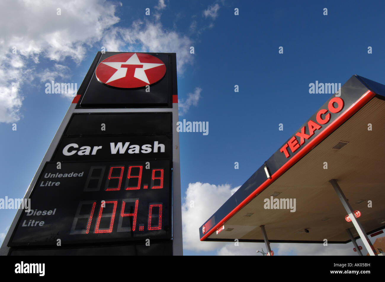 Fuel prices displayed on petrol pumps at 99.8p petrol and 89p diesel at a Texaco garage Stock Photo