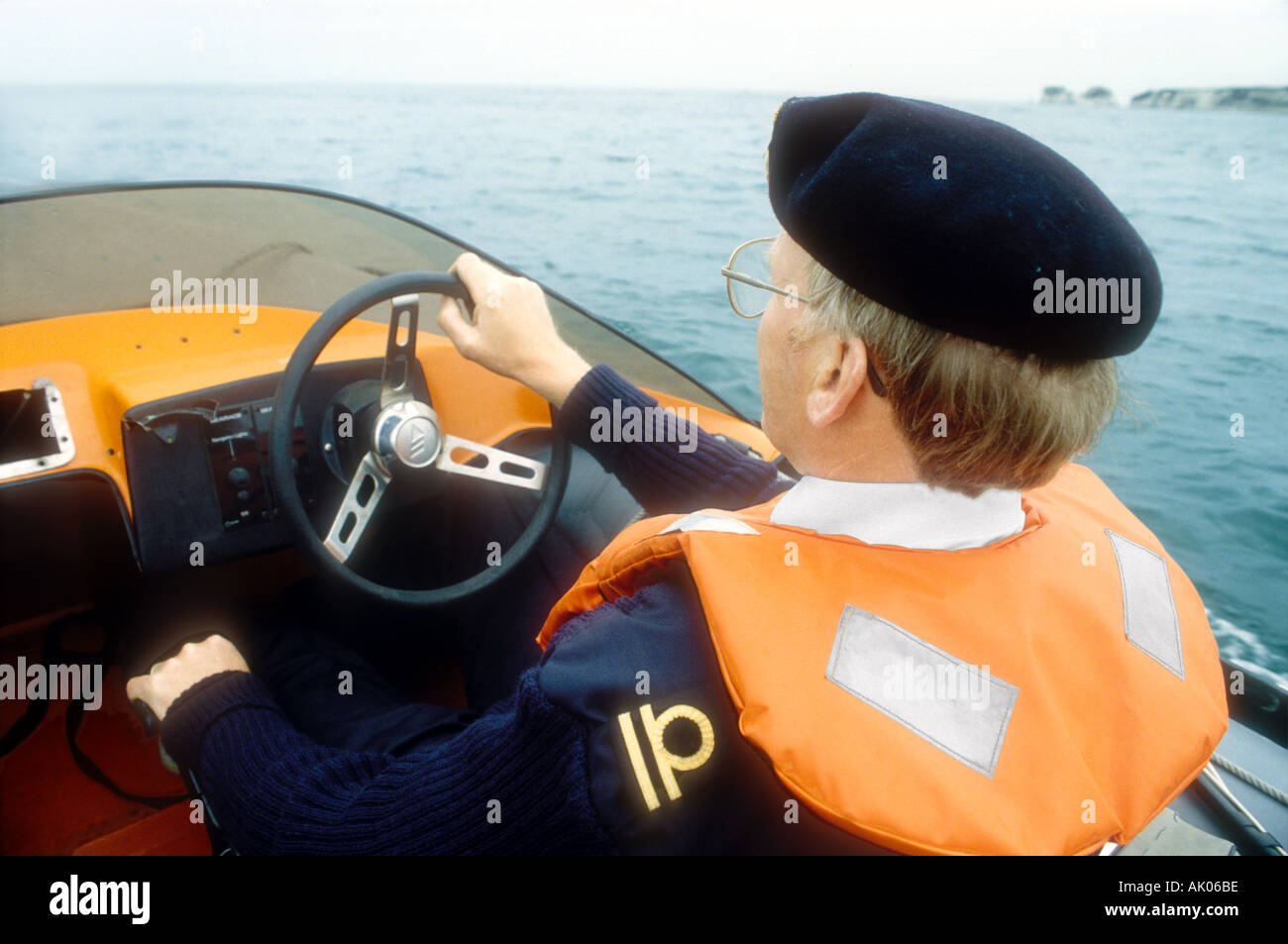 A Customs and Excise officer on patrol in an Avon Sea Rider rigid inflatable boat at Poole Harbour Dorset England UK Stock Photo