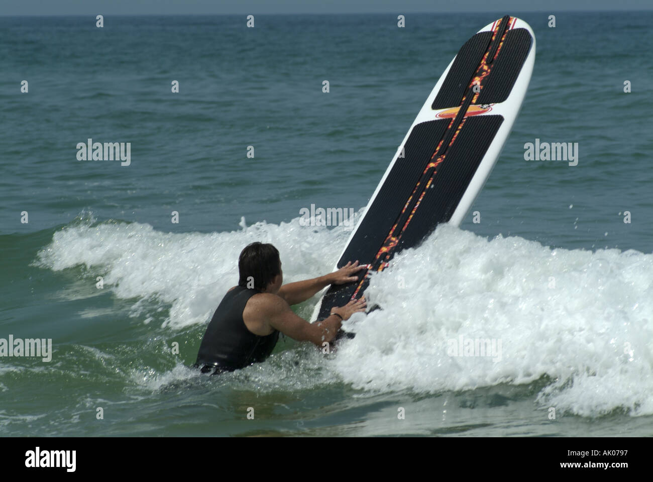 Man surfing a wave at Le Porge beach, Gironde, France. Stock Photo