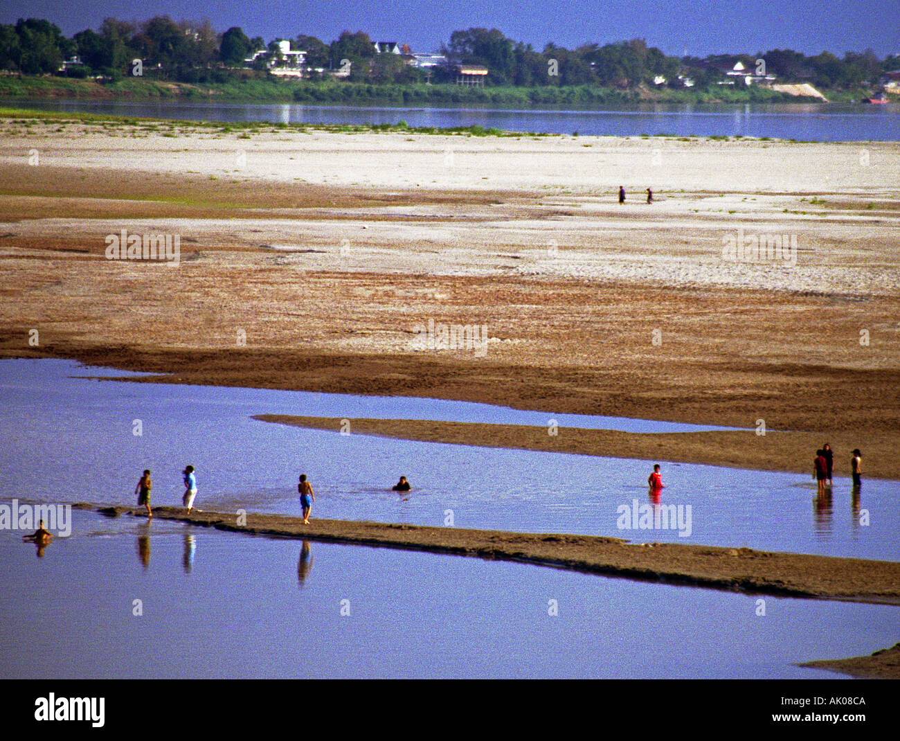 Tropical exotic sand beach sun shine hot summer deep people bath swim refresh Nam Ou River Nong Khiaw Laos Southeast Asia Stock Photo