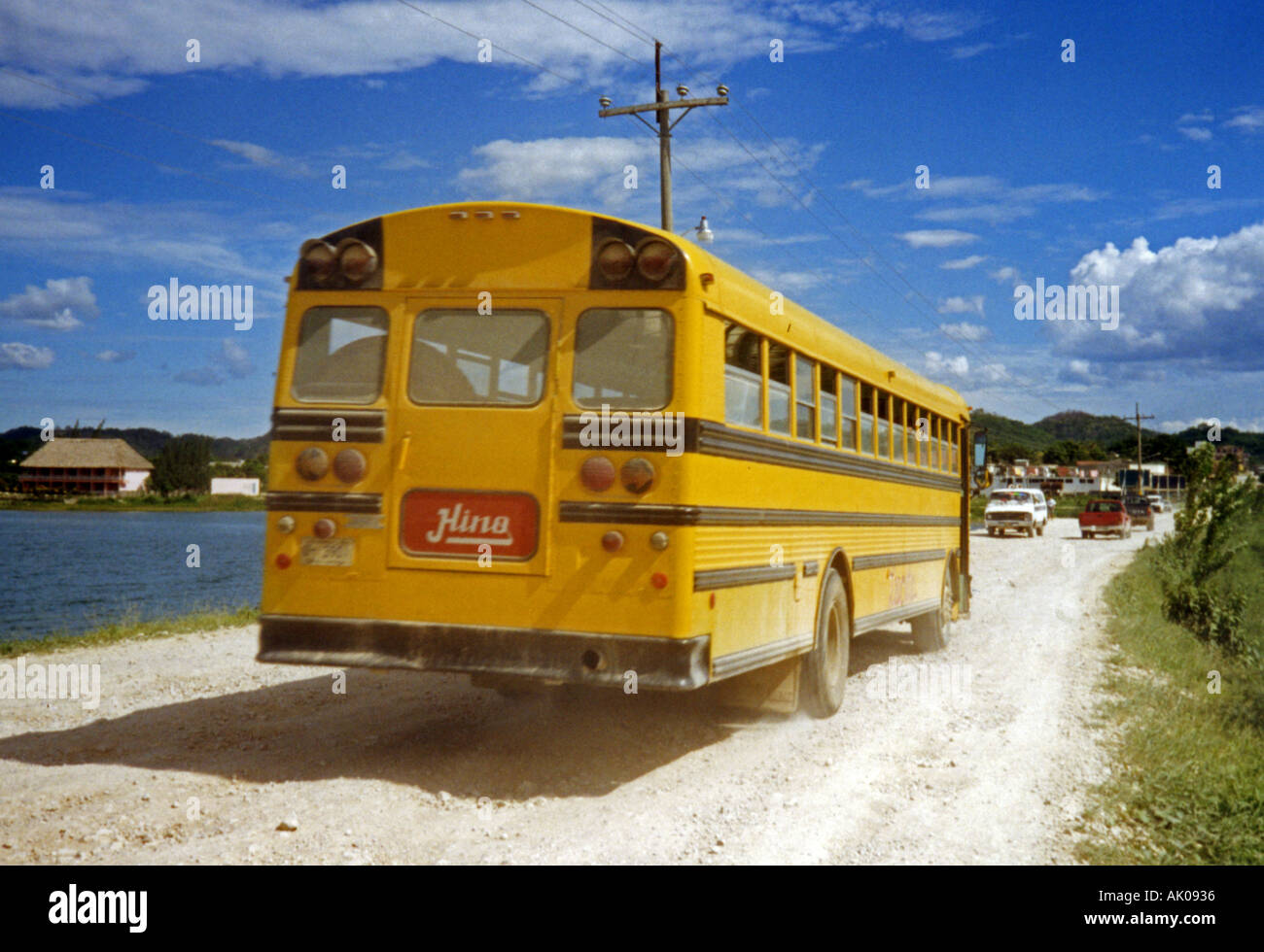 Characteristic tradition bright yellow local bus cross rural Lake Peten Itza Flores Island