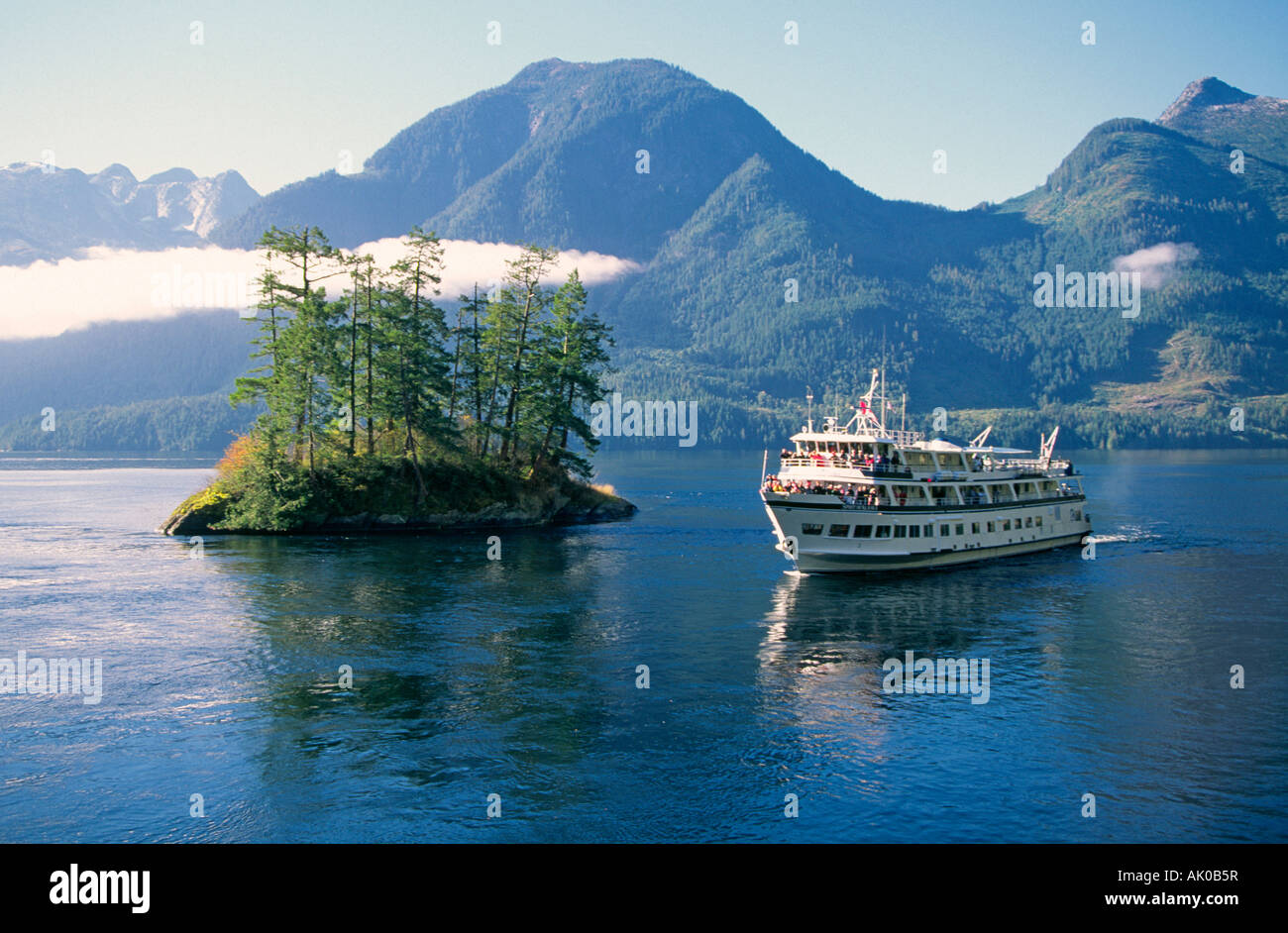 A small cruise ship navigates the bays and straights of the Inside Passage This is Princess Louisa Inlet along the coast Stock Photo