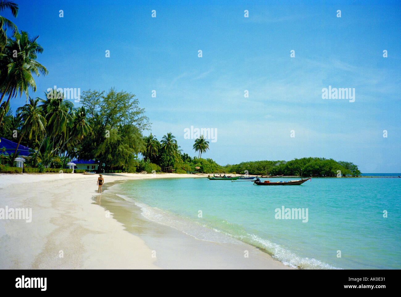 A classic Thai beach view - palm trees, silver sand, and blue green sea Stock Photo