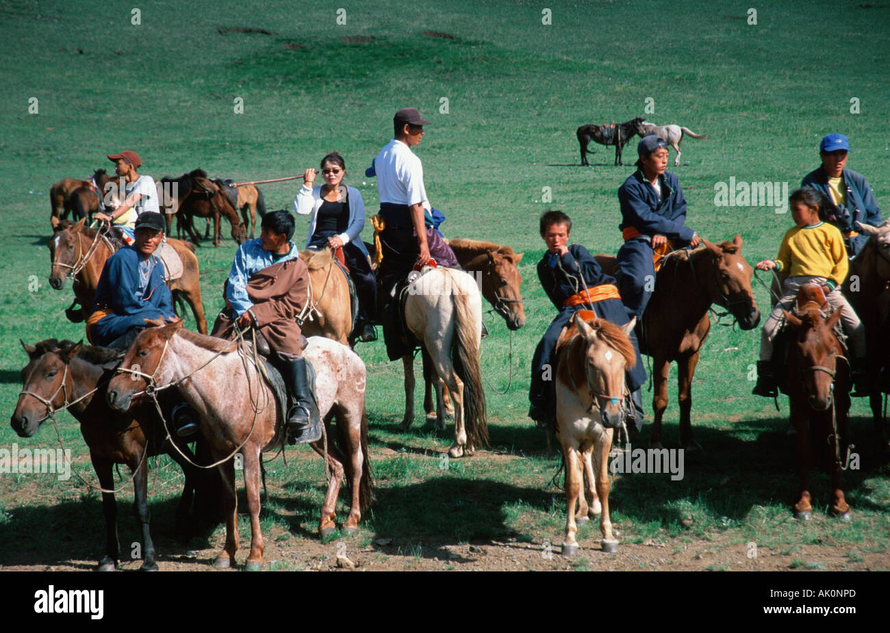 Young Mongolians on horses Stock Photo