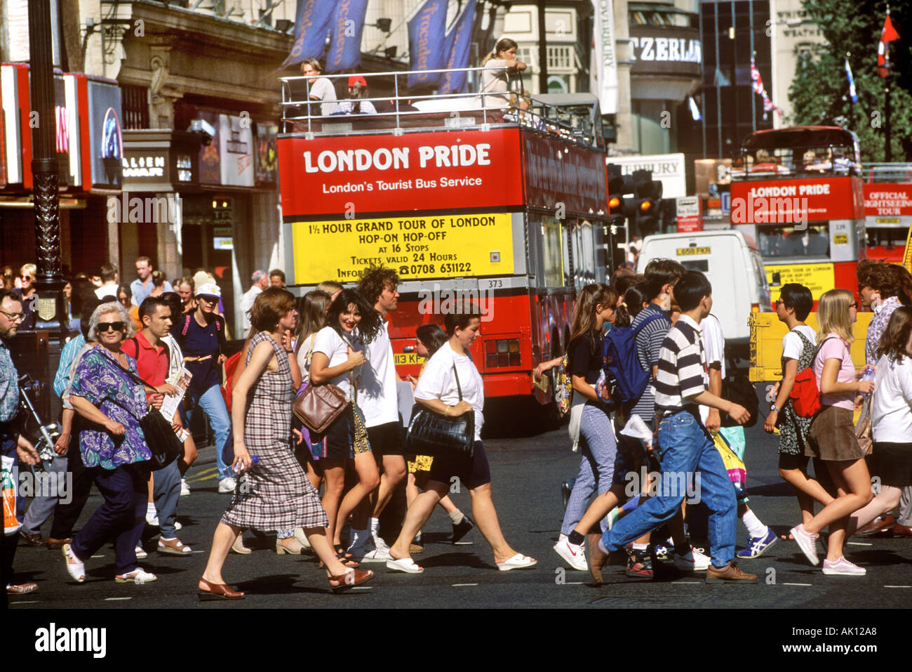 PEOPLE CROSSING A STREET IN LONDON ENGLAND Stock Photo