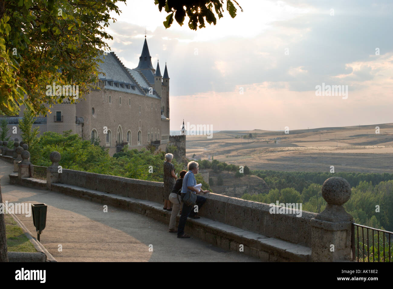 People looking out over the countryside by the Alcazar in the early evening, Segovia, Castilla y Leon, Spain Stock Photo