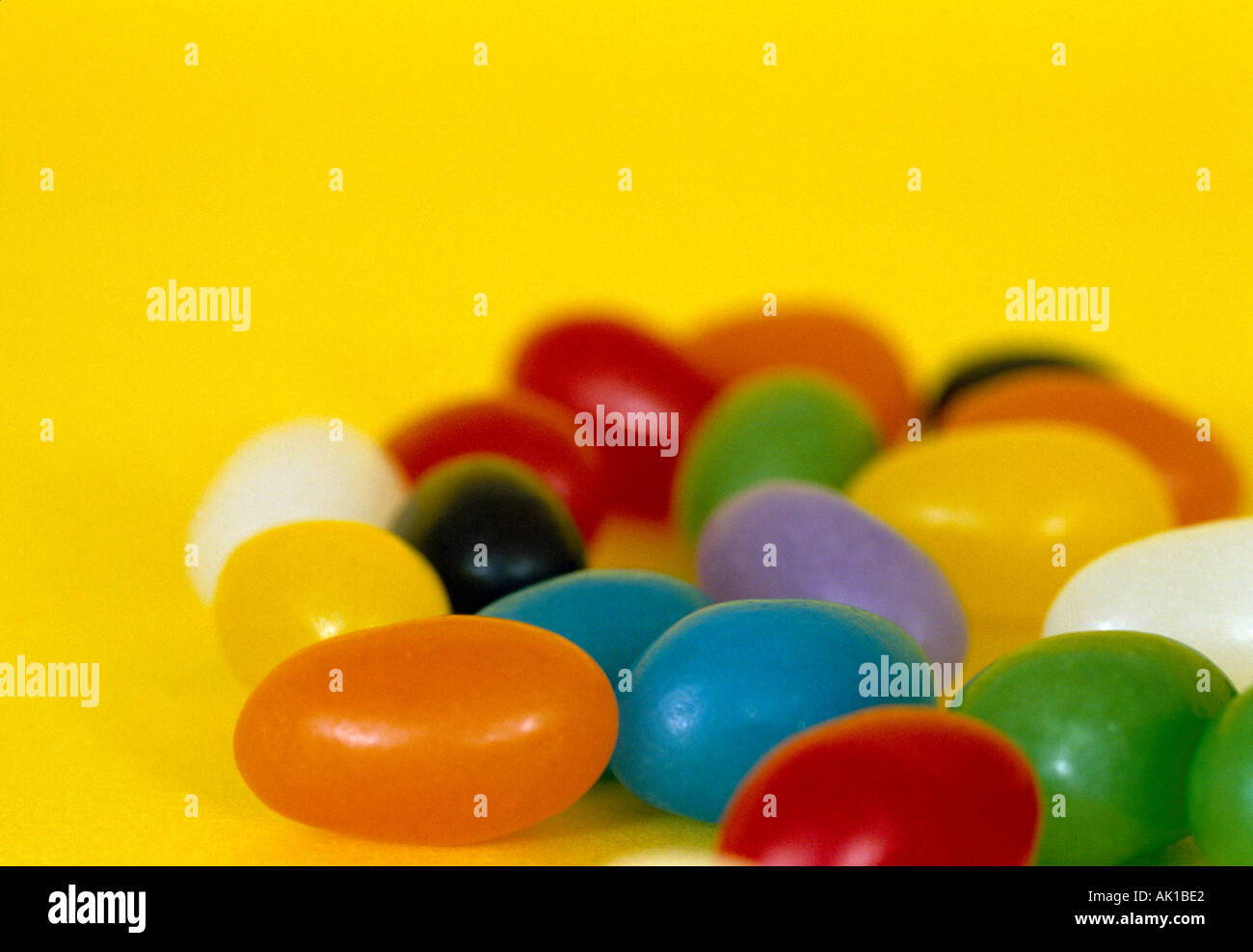 Studio colorful jellybeans on a yellow background Stock Photo