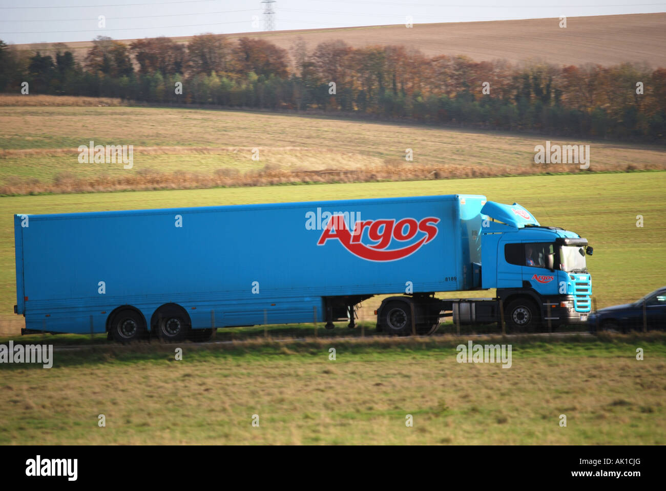 Argos juggernaut driving past Stonehenge, Salisbury Plain, Wiltshire, England, United Kingdom Stock Photo