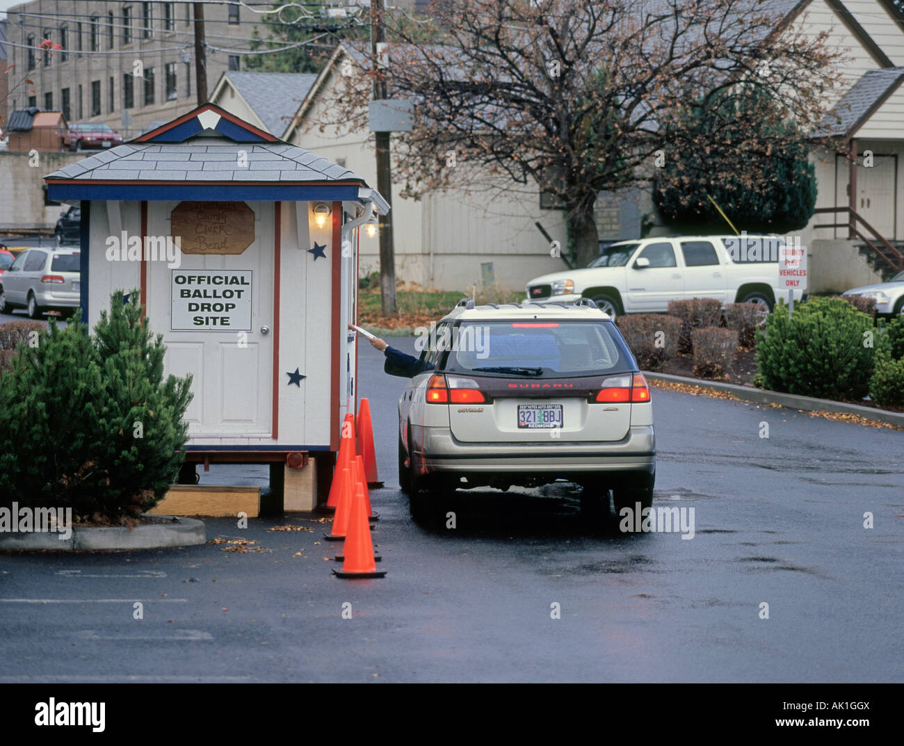 USA OREGON BEND A motorist drops off his mail in ballot at an official ballot drop site in the city of Bend Oregon Stock Photo