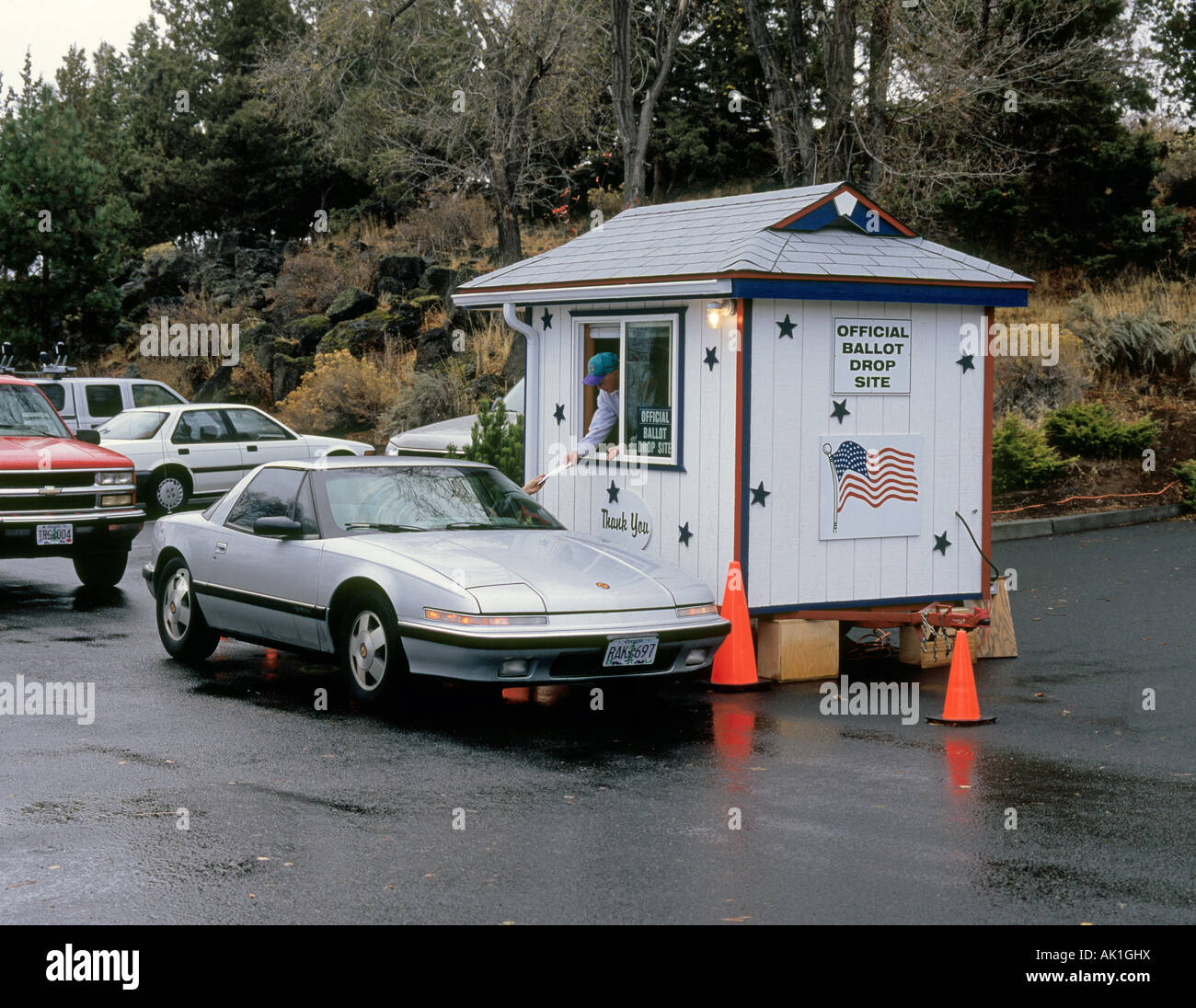 USA OREGON BEND A motorist drops off his mail in ballot at an official ballot drop site Stock Photo