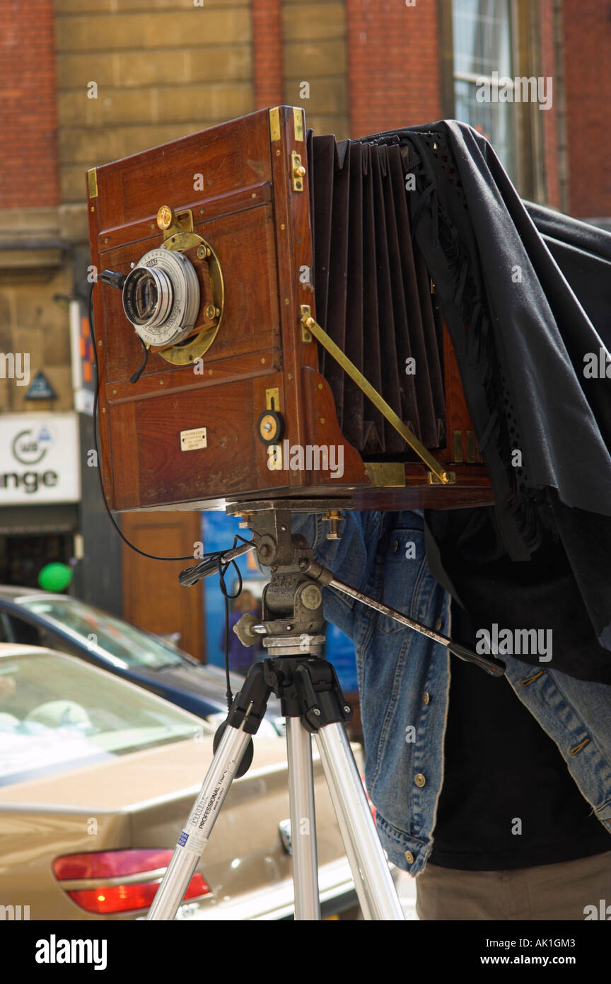 Photographer using antique wooden large format view camera stock photo