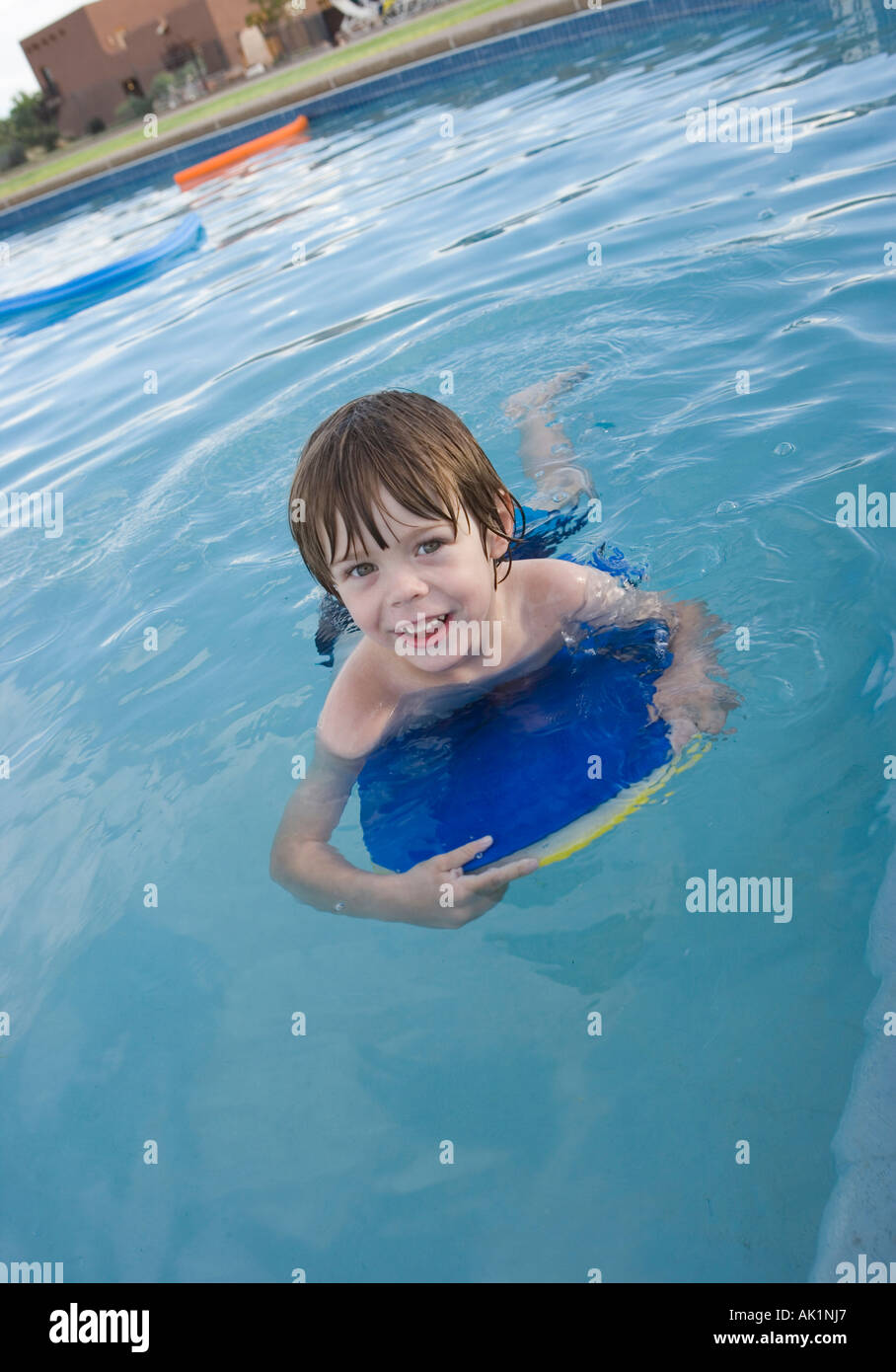 four year old boy with floatation device in swimming pool Stock Photo