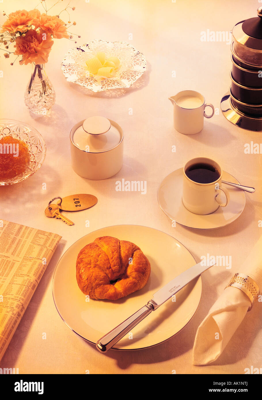 Breakfast setting with coffee and croissant. Stock Photo