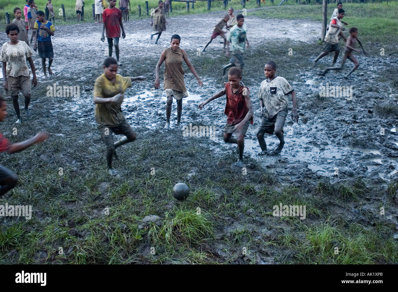 Asmat girls playing football in a mud, Irian Jaya Indonesia. Stock Photo