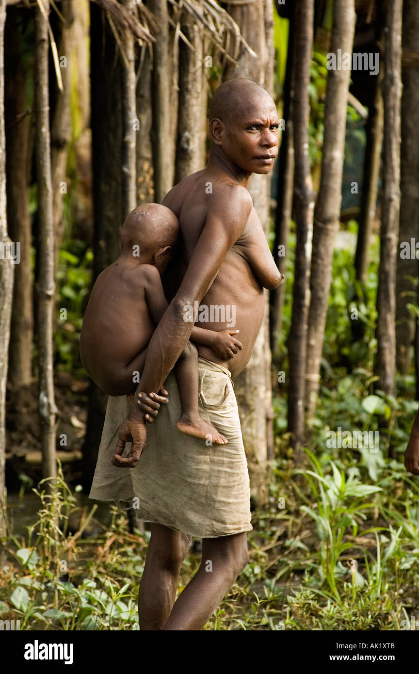 Asmat woman and her baby, Irian Jaya Indonesia. Stock Photo