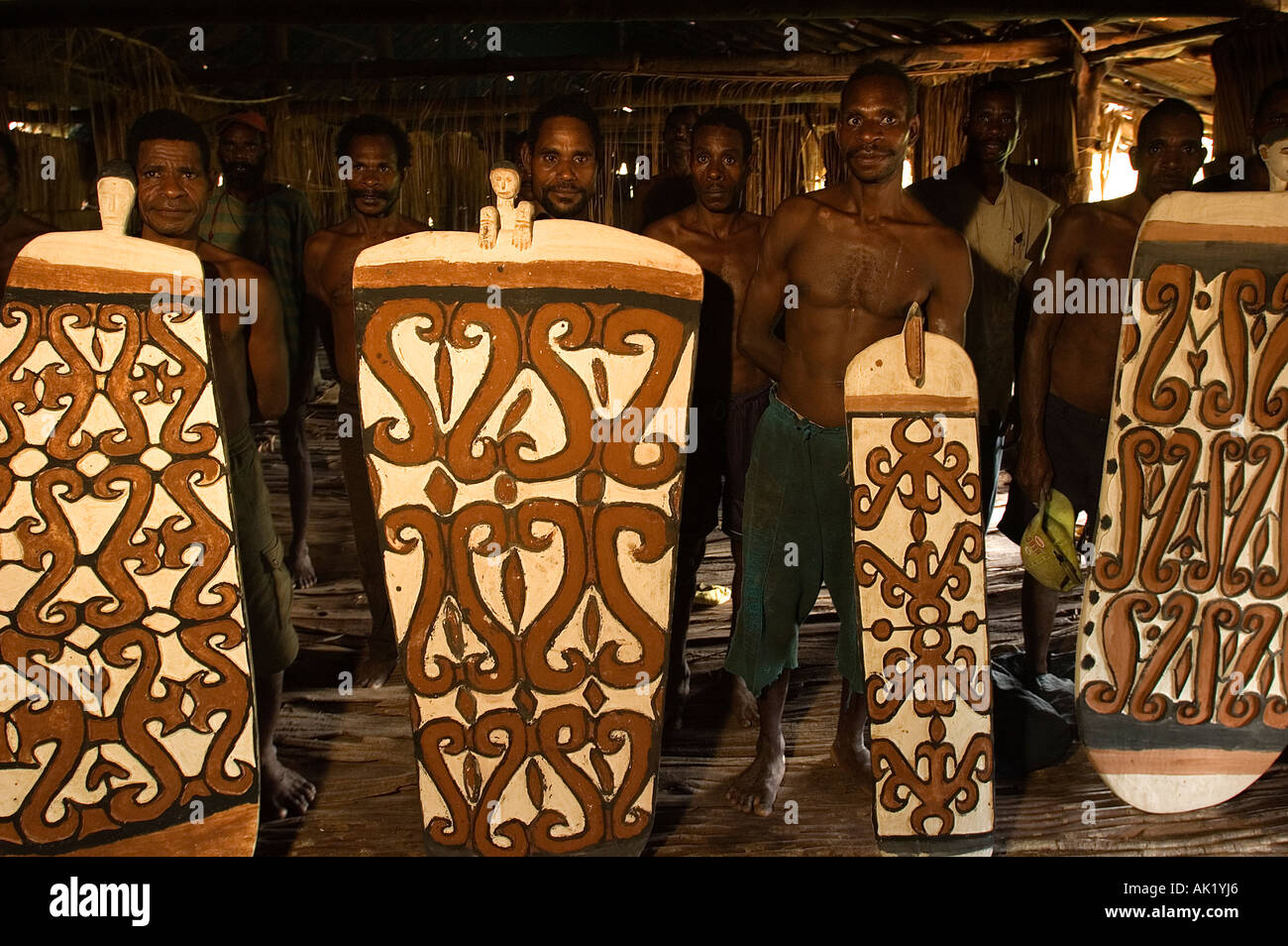 Asmat woodcarvers showing their traditional shields made of tree bark in Omandeseb Village, Irian Jaya, Indonesia. Stock Photo