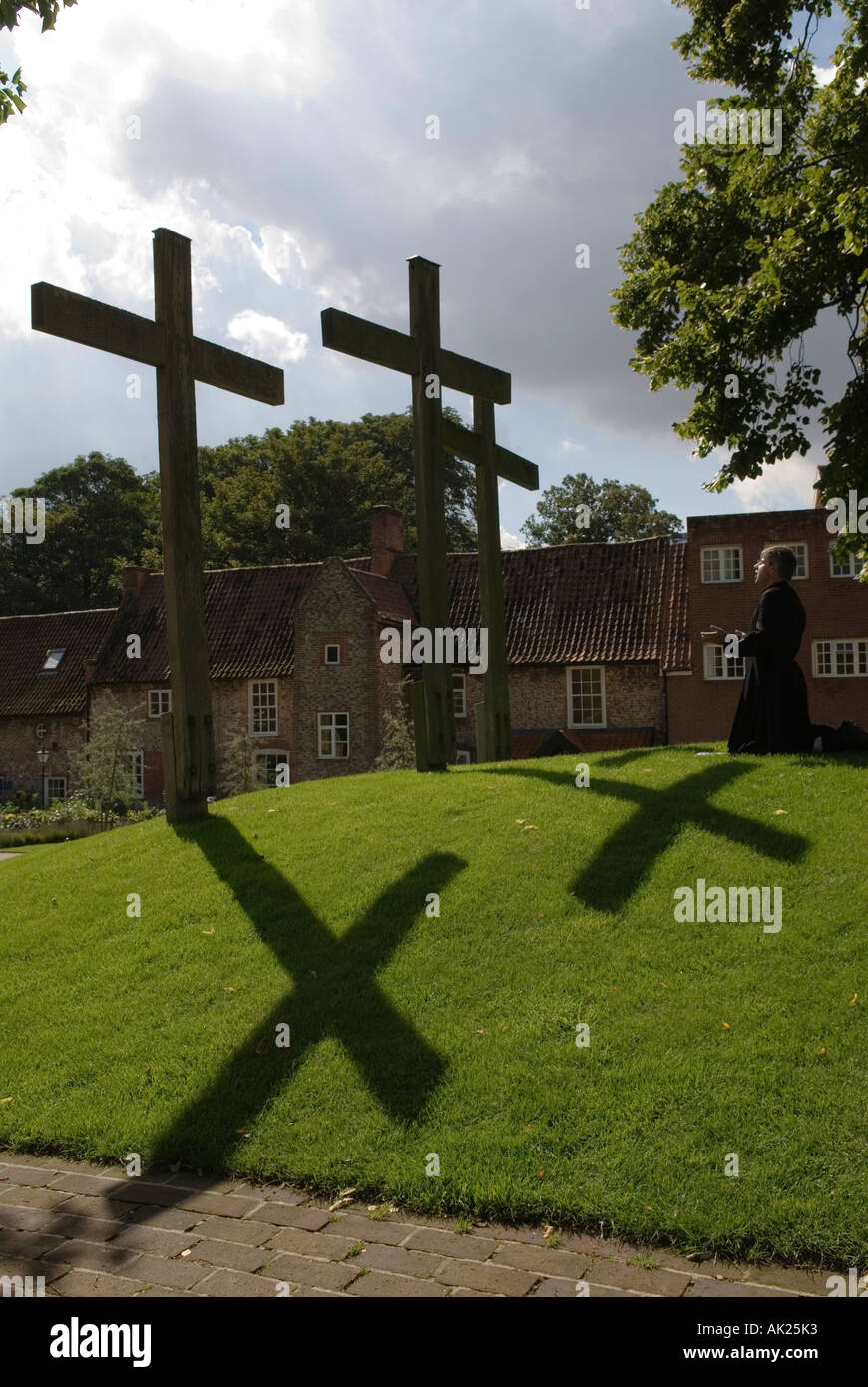 Anglican priests praying In the grounds of The Holy House Englands