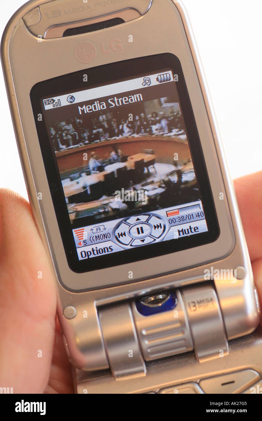 Television news video downloading to a cell or mobile phone Stock Photo