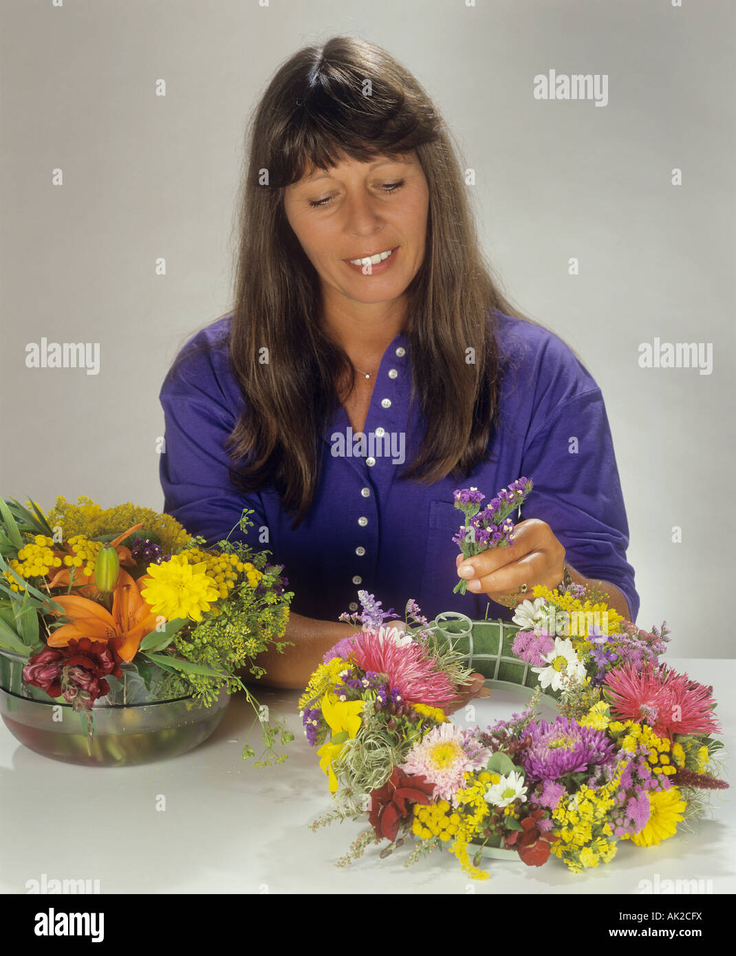 woman making wreath with flowers Stock Photo