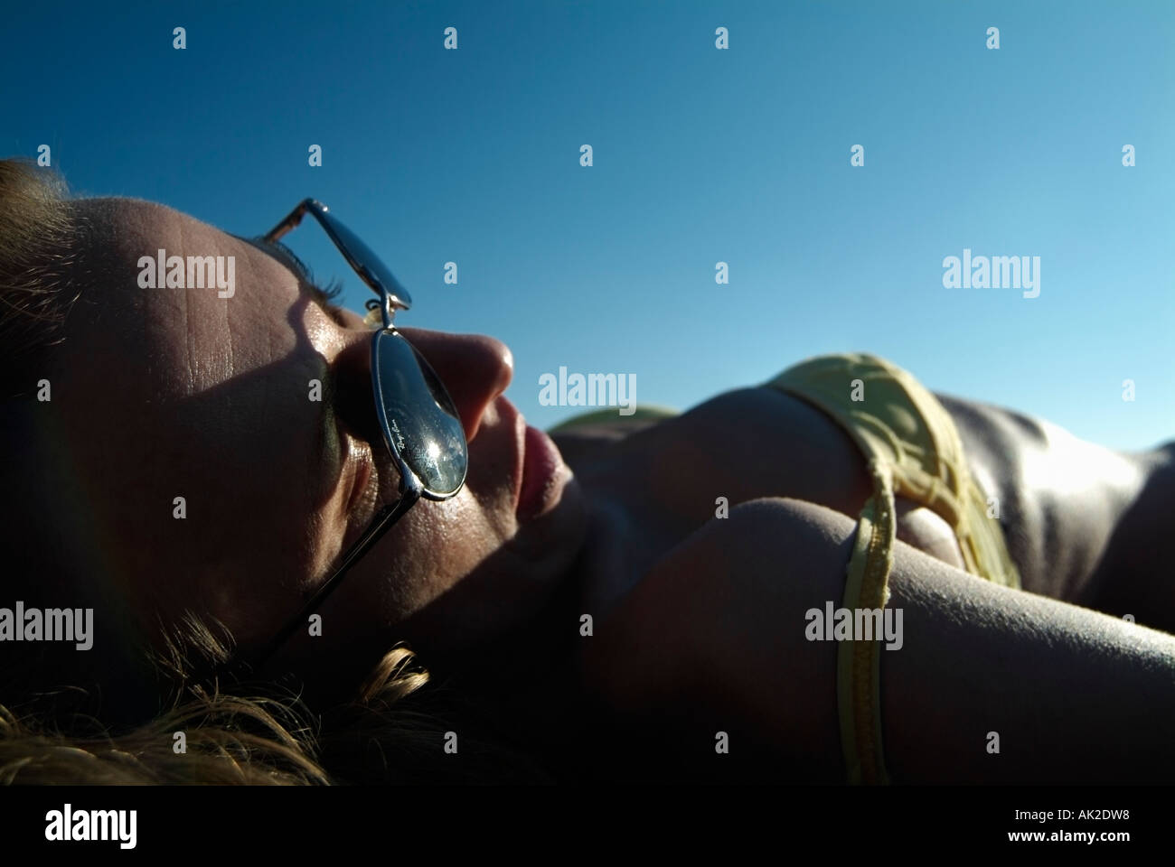 Young Woman Sunbathing on a Beach Low Angle Close Up Stock Photo