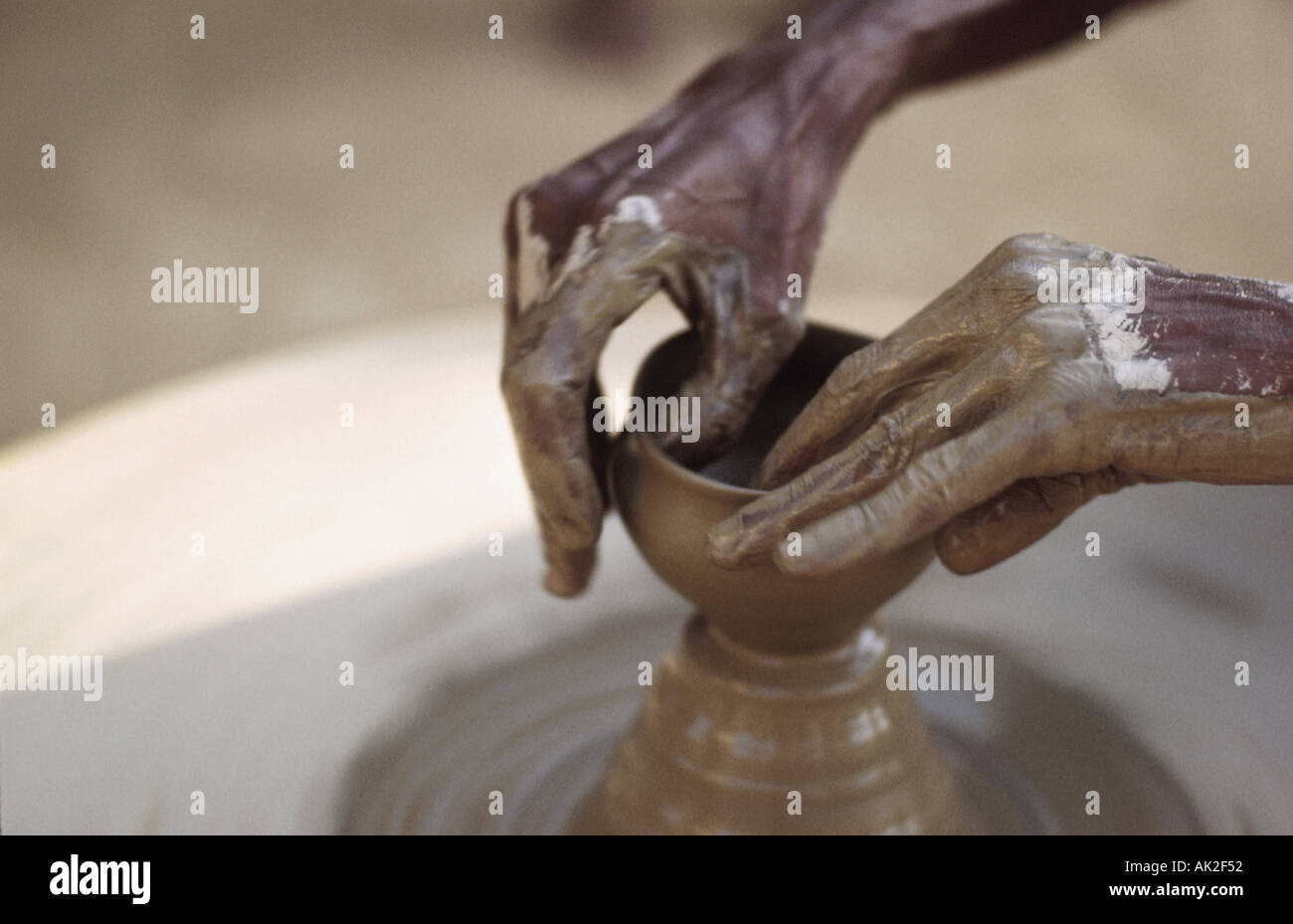 Woman s hands sculpting on potter s wheel in India Stock Photo