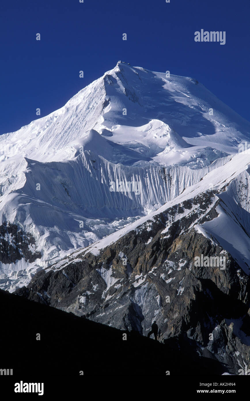 Hiker in front of Chogolisa, Himala Stock Photo