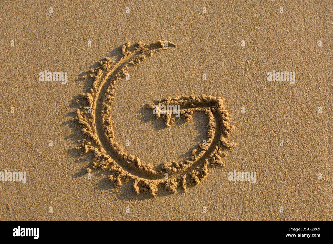 Alphabet hand writen letters on the sand Stock Photo - Alamy