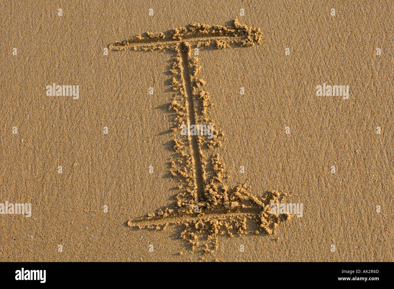 Alphabet hand writen letters on the sand Stock Photo - Alamy