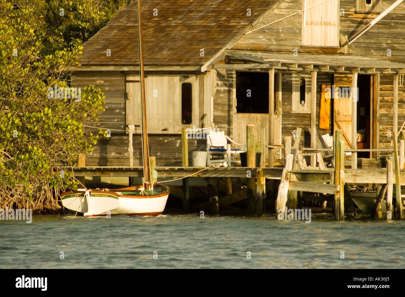 Seaside cottage and sailing dinghy in Man o War Cay Bahamas Stock Photo
