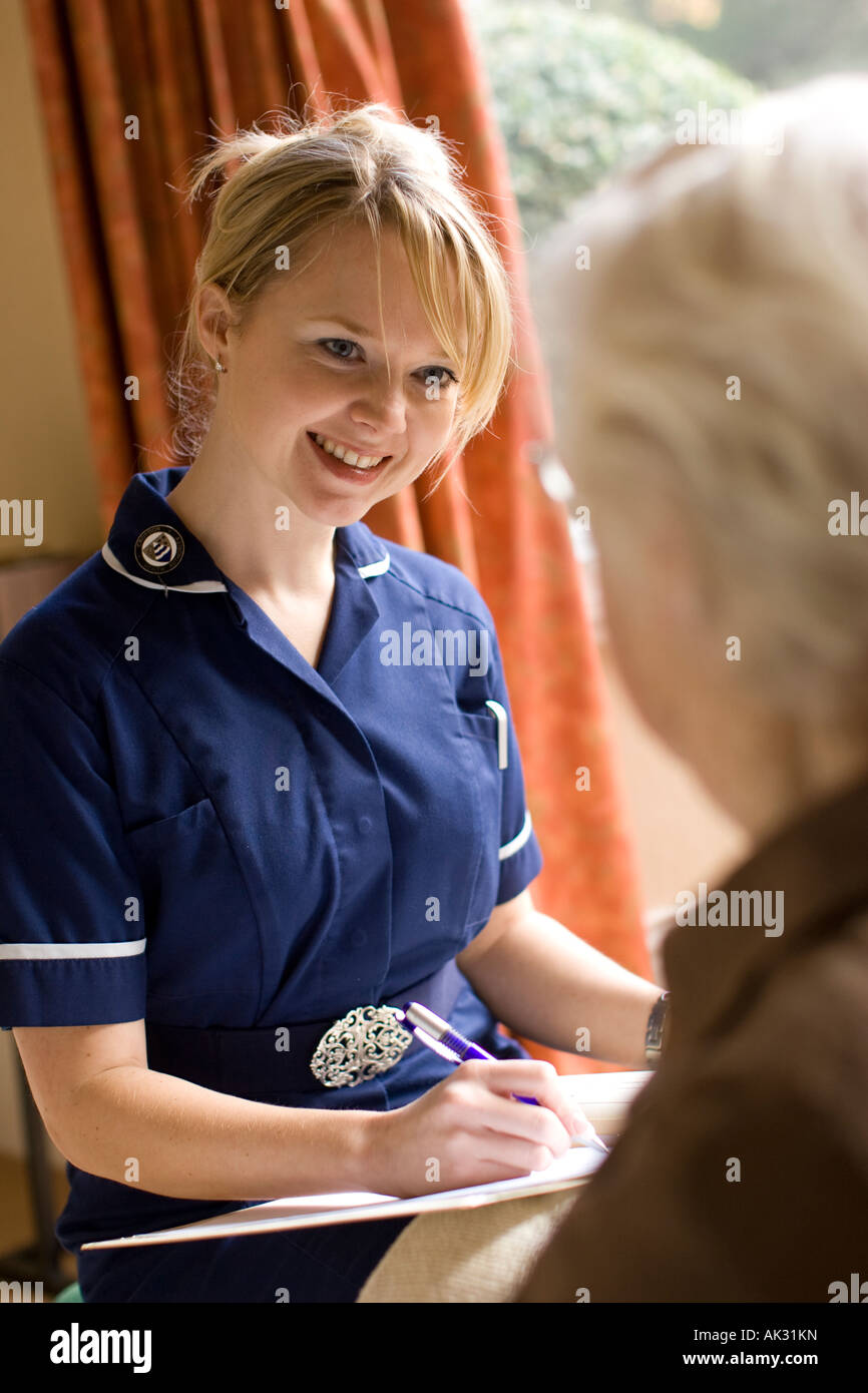 District nurse giving advice on home visit Stock Photo Alamy