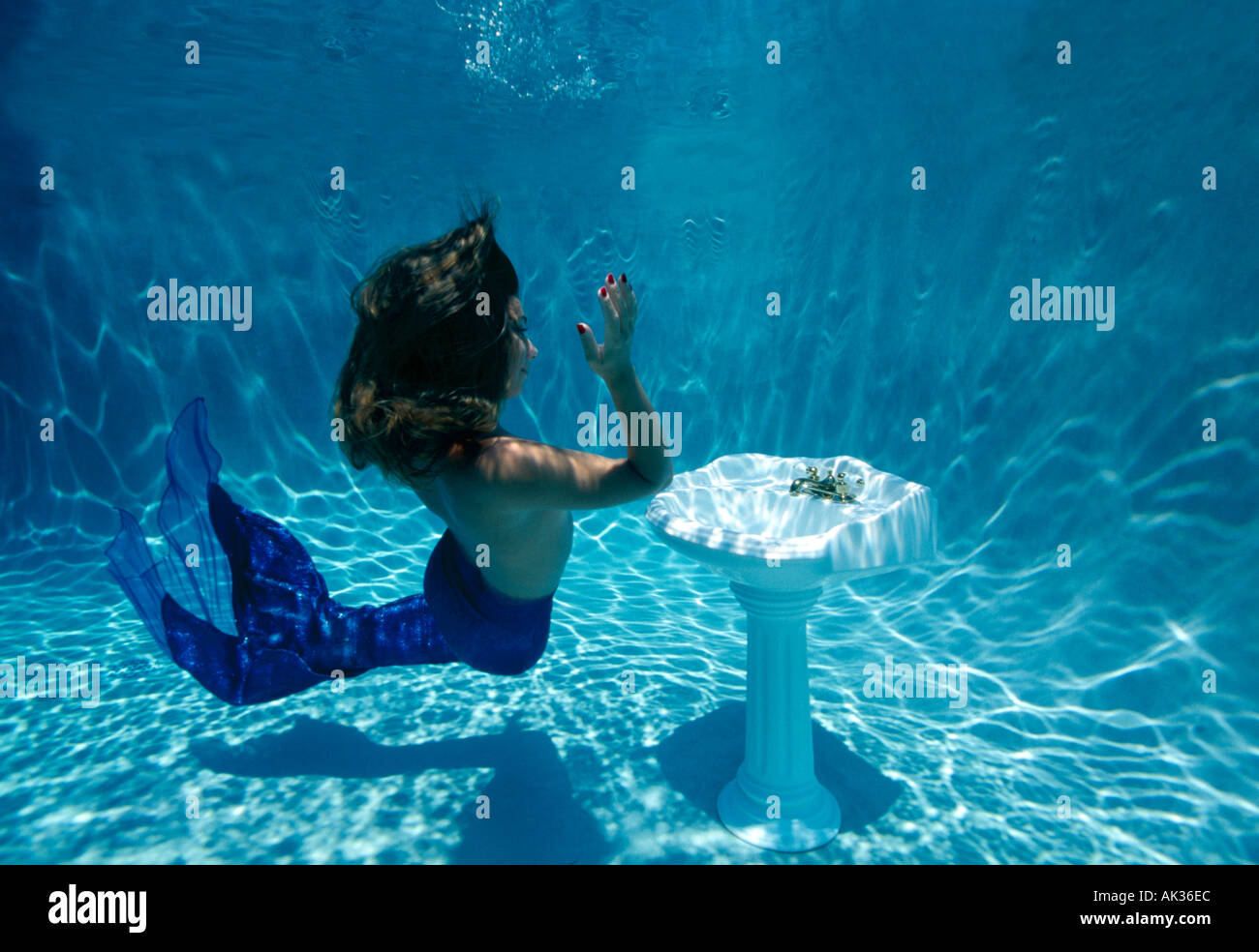 Mermaid and pedestal sink underwater Stock Photo