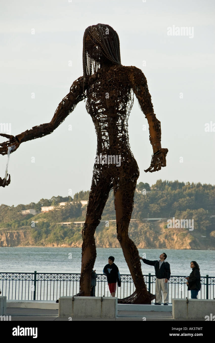 Visitors view Passage sculpture by Dan Das Mann and Karen Cusolito near Pier 14 San Francisco California Stock Photo