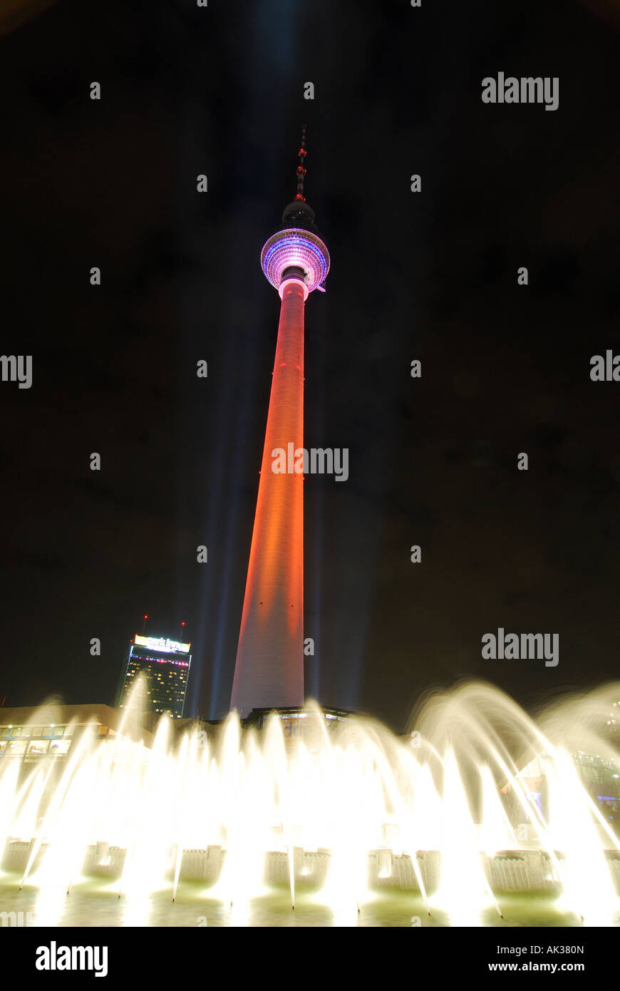 Berlin Alexanderplatz Television tower colourfully illuminated at night Stock Photo