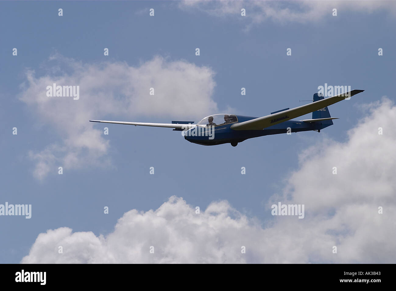 Blue training glider in flight over Sussex, Southern England Stock